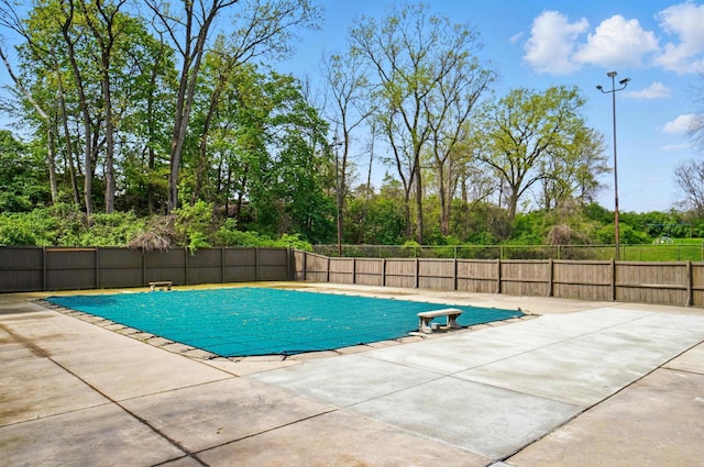 view of swimming pool featuring fence, a fenced in pool, and a patio area