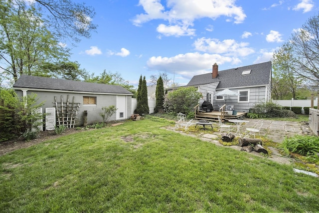view of yard featuring an outdoor fire pit, fence, and a patio area