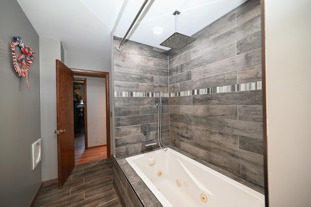 full bathroom featuring baseboards and wood finished floors