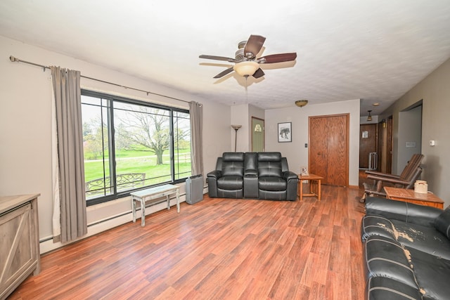 living room featuring light wood-style floors and a ceiling fan