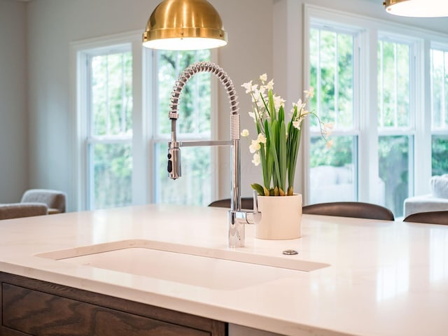 kitchen view of a sink and light countertops
