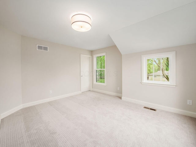 spare room with baseboards and carpet