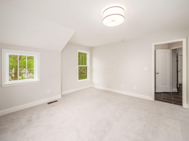 carpeted empty room with baseboards