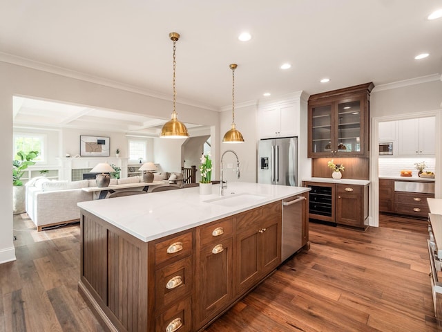 kitchen featuring appliances with stainless steel finishes, a sink, a warming drawer, tasteful backsplash, and glass insert cabinets