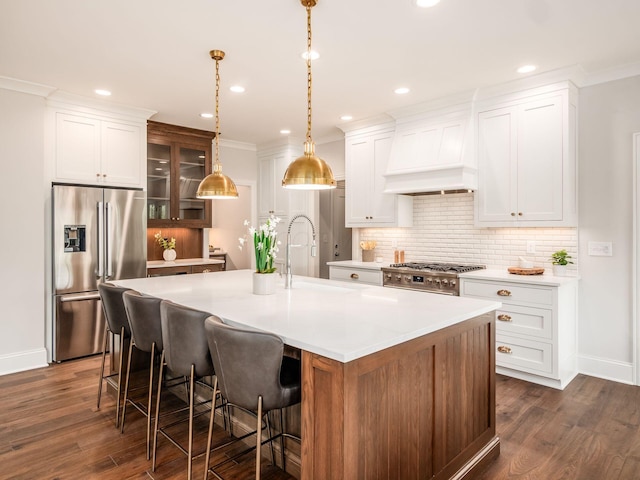 kitchen featuring high quality fridge, dark wood finished floors, light countertops, decorative backsplash, and recessed lighting