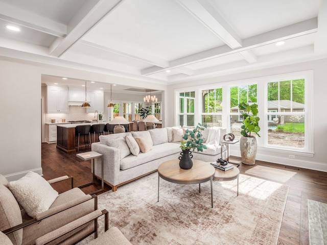 living area featuring coffered ceiling, recessed lighting, beam ceiling, dark wood-style floors, and a chandelier