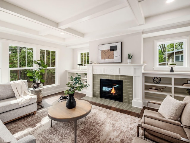 living area featuring beamed ceiling, a fireplace, recessed lighting, wood finished floors, and coffered ceiling
