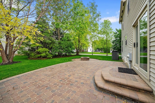 2977 Highwall Way, Columbus, OH 43221 - view of patio / terrace featuring an outdoor fire pit and central AC