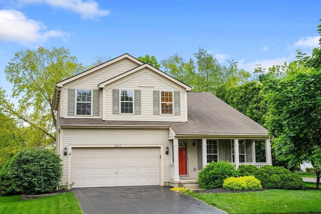 2977 Highwall Way, Columbus, OH 43221 - traditional home featuring driveway, an attached garage, a front yard, and covered porch