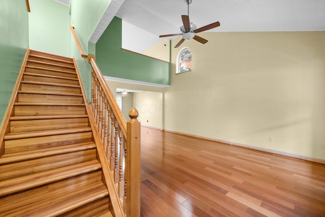 2977 Highwall Way, Columbus, OH 43221 - stairs with ceiling fan, wood finished floors, high vaulted ceiling, and baseboards