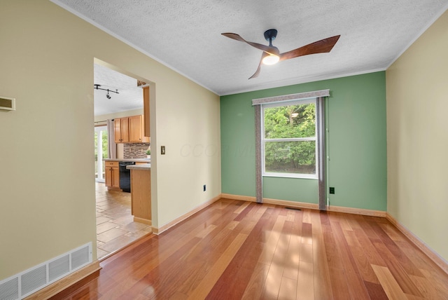 2977 Highwall Way, Columbus, OH 43221 - spare room featuring plenty of natural light, ceiling fan, baseboards, light wood finished floors, and ornamental molding