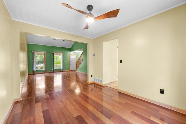 2977 Highwall Way, Columbus, OH 43221 - empty room with wood finished floors, stairway, a ceiling fan, baseboards, and crown molding
