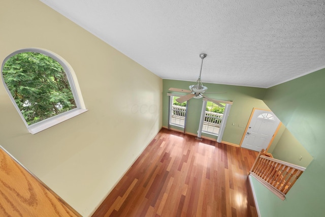 2977 Highwall Way, Columbus, OH 43221 - unfurnished dining area with wood finished floors, ceiling fan, a textured ceiling, and baseboards