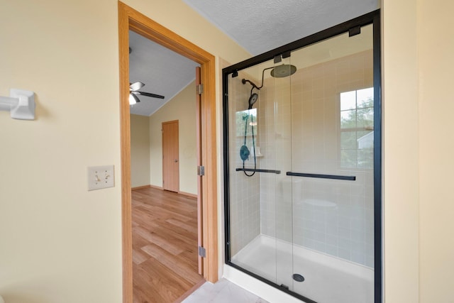 2977 Highwall Way, Columbus, OH 43221 - bathroom with a stall shower, a textured ceiling, a ceiling fan, lofted ceiling, and wood finished floors
