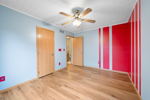 2977 Highwall Way, Columbus, OH 43221 - unfurnished bedroom with wood finished floors, a textured ceiling, a ceiling fan, ornamental molding, and baseboards
