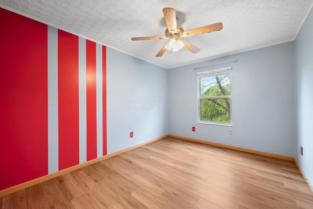 2977 Highwall Way, Columbus, OH 43221 - spare room with light wood-style floors, a ceiling fan, baseboards, and a textured ceiling