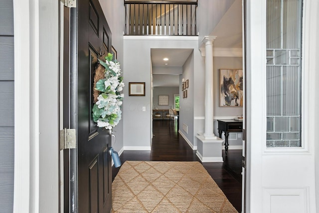 298 Long Branch Run, Delaware, OH 43015 - entryway featuring ornate columns, dark wood-type flooring, a high ceiling, and ornamental molding