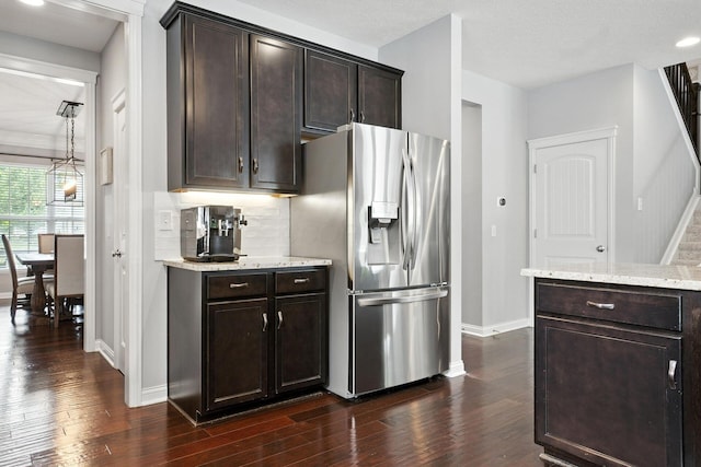 298 Long Branch Run, Delaware, OH 43015 - kitchen featuring stainless steel fridge, dark wood-type flooring, dark brown cabinets, and light stone countertops