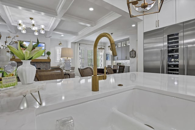 5519 Evans Farm Dr, Lewis Center, OH 43035 - kitchen with coffered ceiling, a notable chandelier, crown molding, built in refrigerator, and beamed ceiling