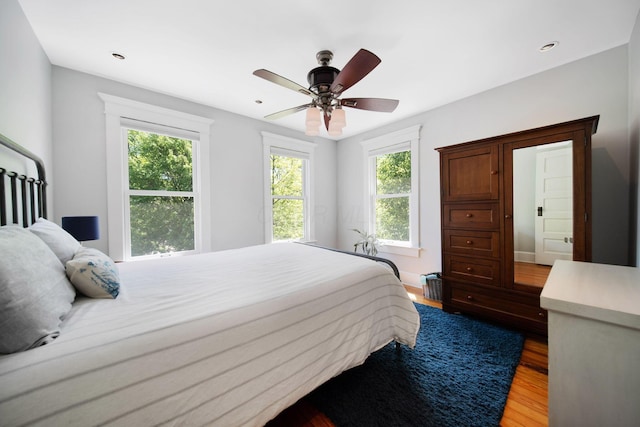 bedroom with recessed lighting, ceiling fan, and wood finished floors