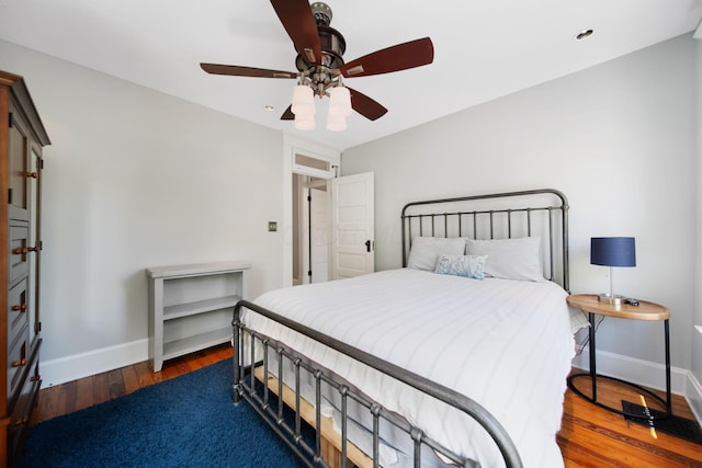 bedroom featuring baseboards, ceiling fan, and hardwood / wood-style flooring
