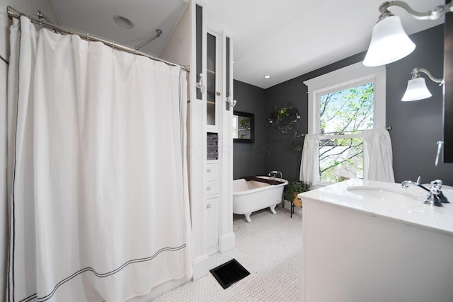 full bath featuring visible vents, a shower with shower curtain, vanity, and a soaking tub