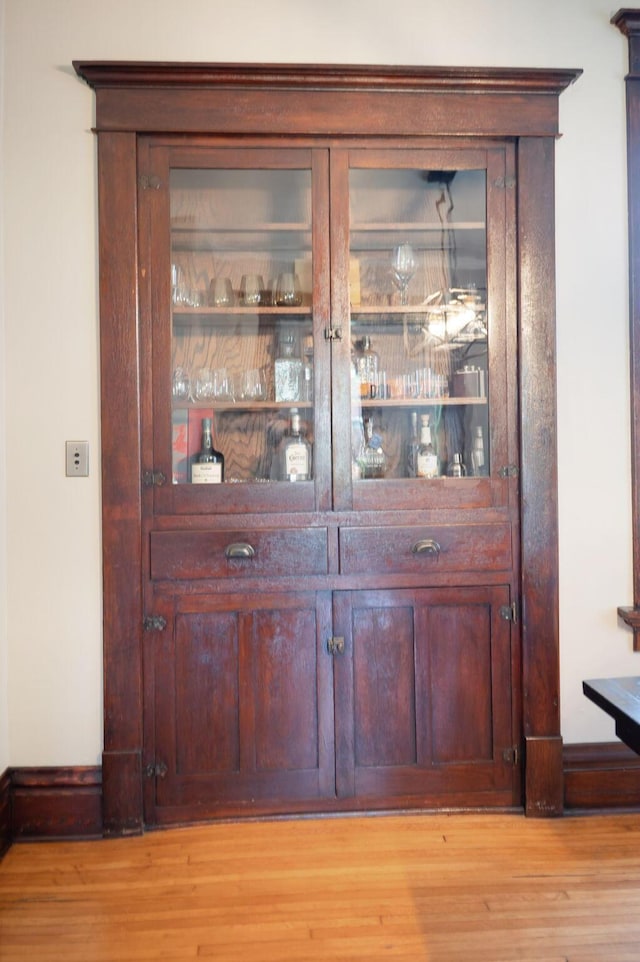 interior details featuring baseboards and wood finished floors