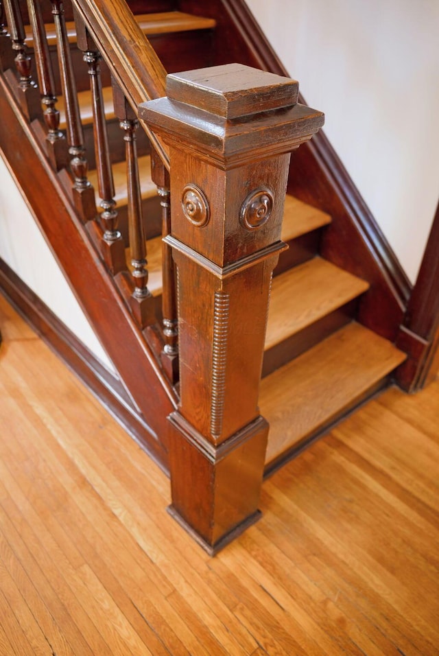 stairway featuring wood finished floors