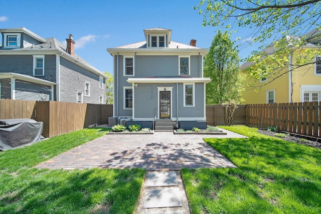 back of property with central air condition unit, a patio, a fenced backyard, and a lawn