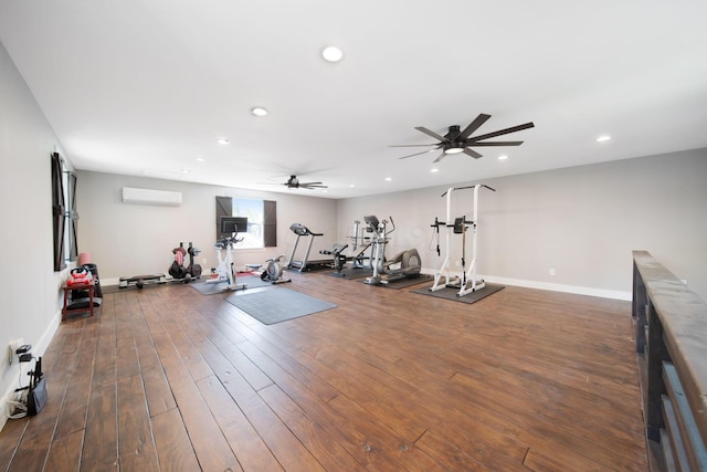 exercise room with a ceiling fan, dark wood-style flooring, a wall mounted AC, baseboards, and recessed lighting