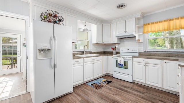 kitchen featuring white appliances, white cabinetry, under cabinet range hood, and a sink