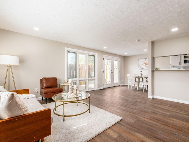 living room with a textured ceiling, wood finished floors, and recessed lighting