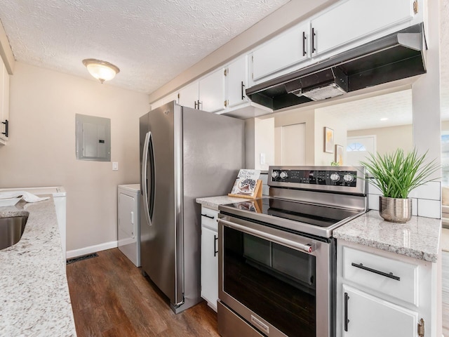 kitchen featuring washer and dryer, under cabinet range hood, appliances with stainless steel finishes, electric panel, and dark wood-type flooring