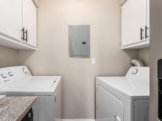 laundry area featuring washer and dryer, cabinet space, and electric panel