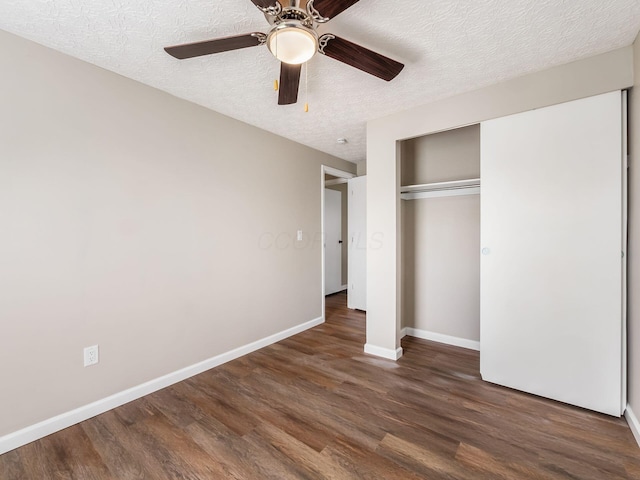 unfurnished bedroom featuring a closet, ceiling fan, baseboards, a textured ceiling, and wood finished floors