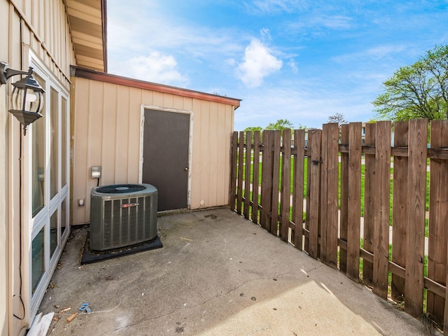 view of patio featuring fence and central AC unit