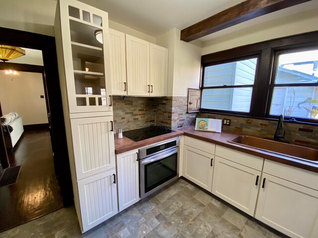 110 N Ogden Ave, Columbus, OH 43204 - kitchen with a sink, backsplash, stainless steel oven, and black electric cooktop
