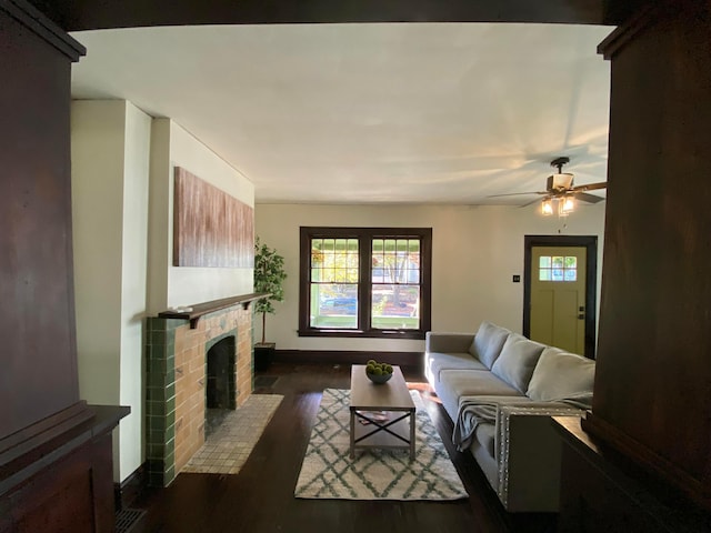 110 N Ogden Ave, Columbus, OH 43204 - living area with a brick fireplace, a ceiling fan, dark wood-style flooring, and baseboards