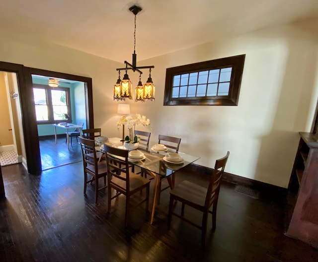 110 N Ogden Ave, Columbus, OH 43204 - dining area featuring an inviting chandelier, wood finished floors, and baseboards