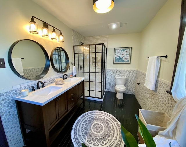 110 N Ogden Ave, Columbus, OH 43204 - bathroom featuring walk in shower, tile walls, a sink, and wainscoting