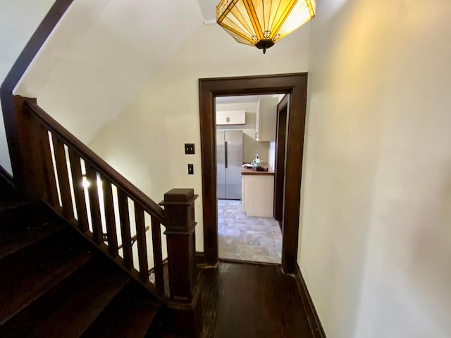 110 N Ogden Ave, Columbus, OH 43204 - stairway featuring vaulted ceiling, wood finished floors, and baseboards