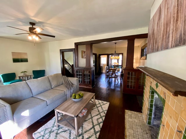 110 N Ogden Ave, Columbus, OH 43204 - living area featuring dark wood-style floors, ceiling fan with notable chandelier, and a fireplace