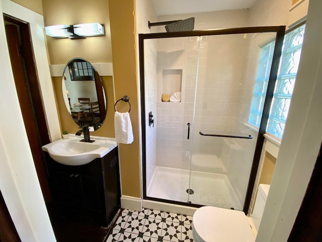 110 N Ogden Ave, Columbus, OH 43204 - bathroom with vanity, toilet, a shower stall, and baseboards