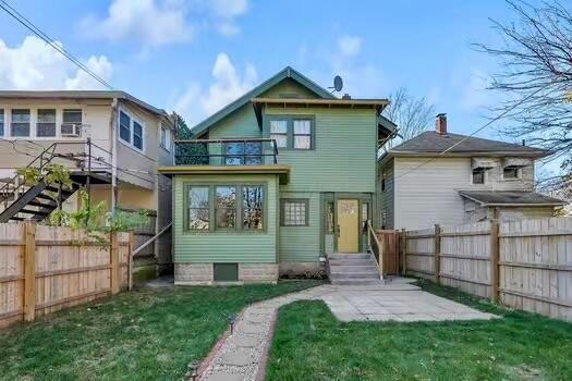110 N Ogden Ave, Columbus, OH 43204 - rear view of property featuring a fenced backyard, a balcony, a patio area, and a lawn