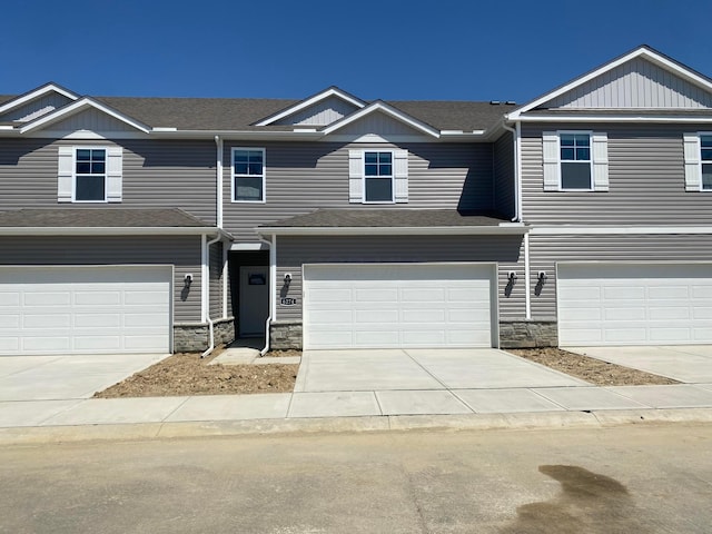 6274 Marinelli Dr S, Columbus, OH 43228 - multi unit property featuring concrete driveway, stone siding, and an attached garage