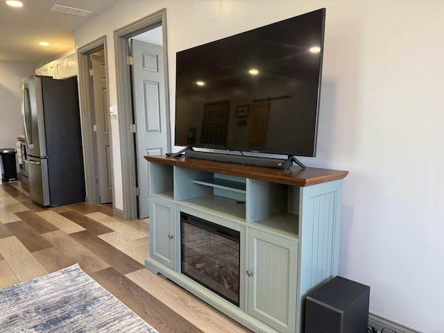 interior space featuring visible vents, recessed lighting, and light wood finished floors