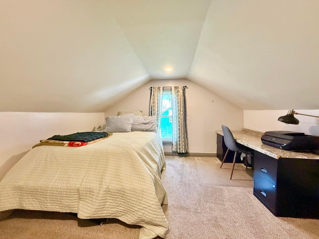 bedroom featuring baseboards, lofted ceiling, and light colored carpet