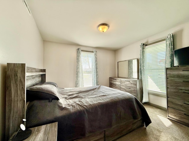 carpeted bedroom featuring baseboards