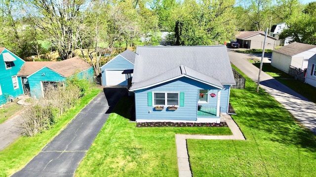 view of front of home with a front yard and a garage