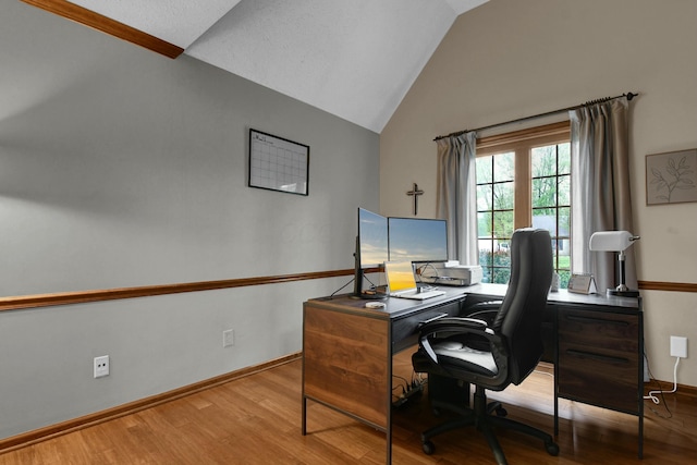 home office with baseboards, high vaulted ceiling, and wood finished floors